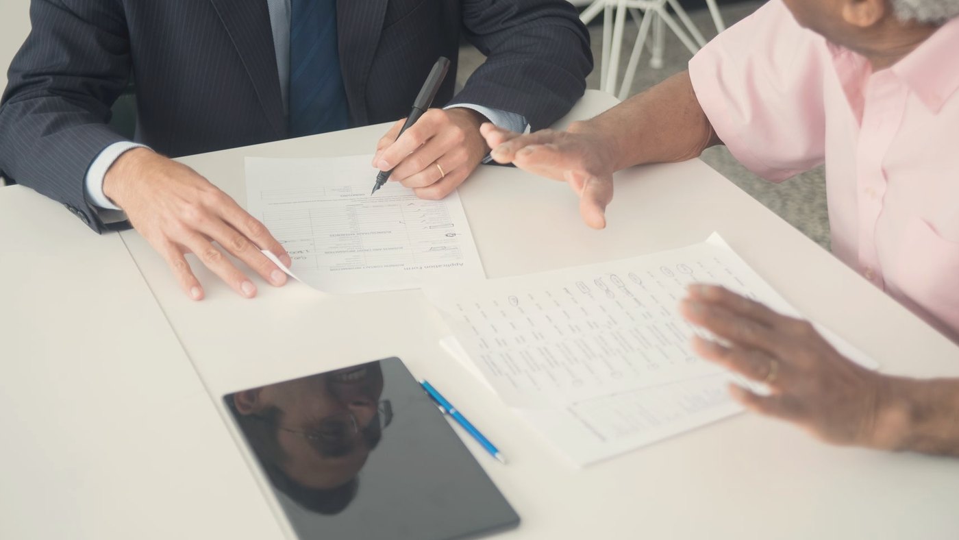 Client and consultant discussing documents at an office table