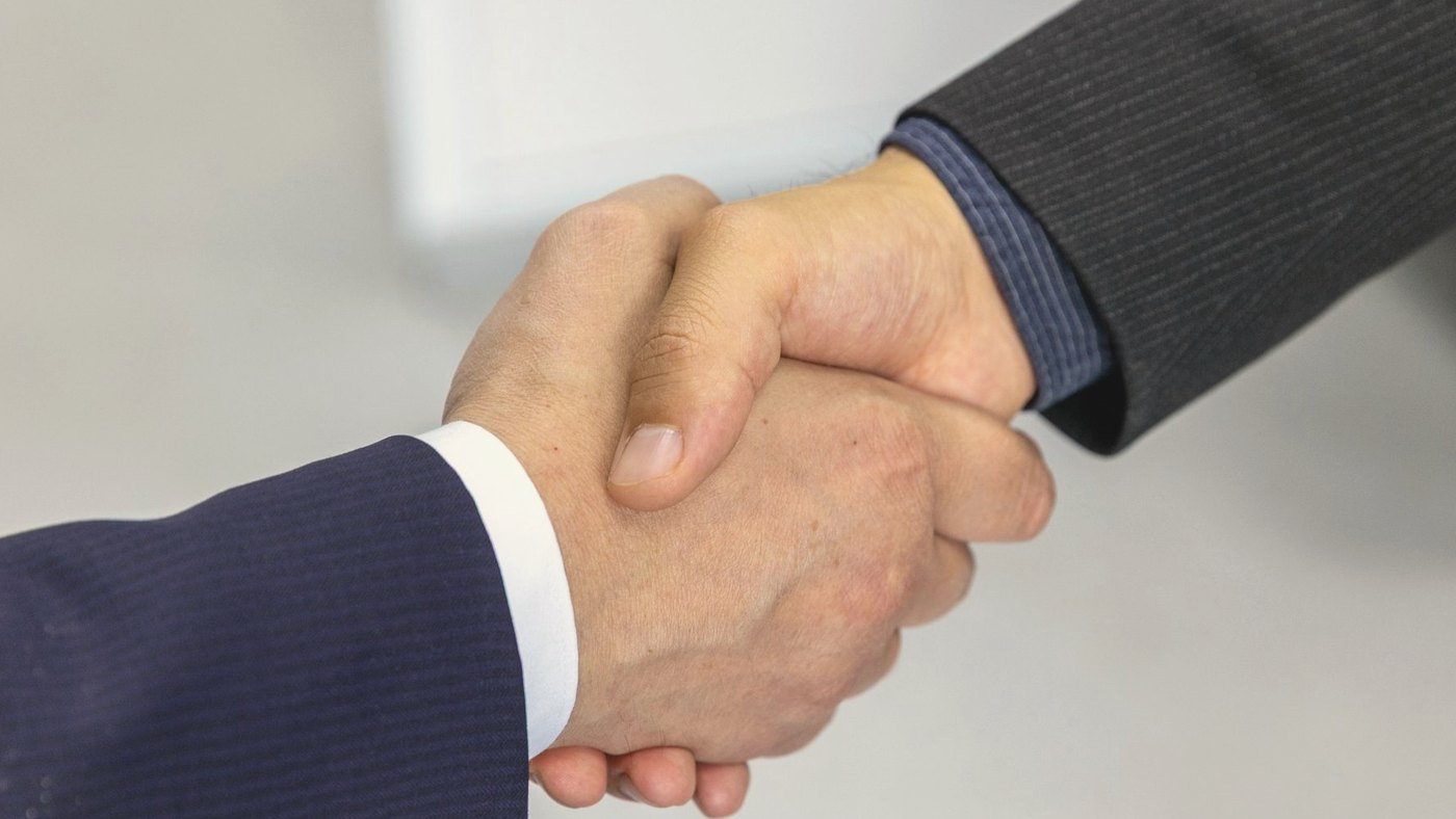 Close-up of two businessmen shaking hands in agreement